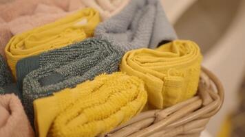 A storage basket made of wood filled with an assortment of towels video