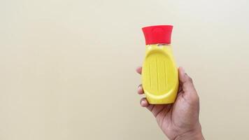 top view of holding a mustard mayonnaise container video
