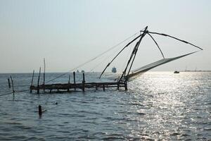 Chinese fishnets on sunset. Kochi, Kerala, India photo