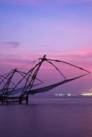 Chinese fishnets on sunset. Kochi, Kerala, India photo