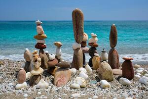 Concept of balance and harmony - pebble stone stacks on the beach photo