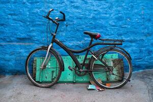 Bicycle by blue house in streets of of Jodhpur photo