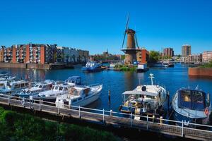 View of the harbour of Delfshaven and the old grain mill De Destilleerketel. Rotterdam, Netherlands photo