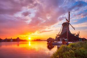 Windmills at Zaanse Schans in Holland on sunset. Zaandam, Nether photo