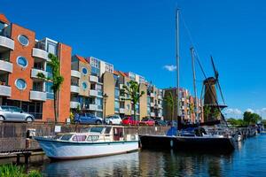 View of the harbour of Delfshaven and the old grain mill De Destilleerketel. Rotterdam, Netherlands photo