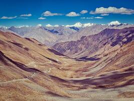 Karakoram Range and road in valley, Ladakh, India photo