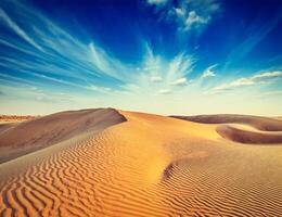 Sand dunes in desert photo