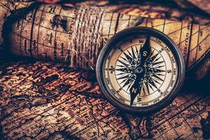 Old vintage compass on ancient map photo