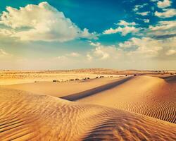 Sand dunes in desert photo