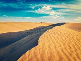 Sand dunes in desert photo