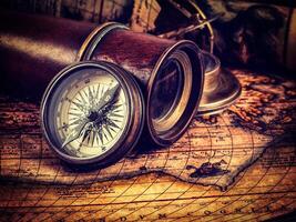 Old vintage compass on ancient map photo