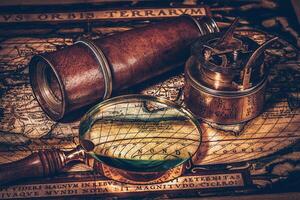 Old vintage compass on ancient map photo