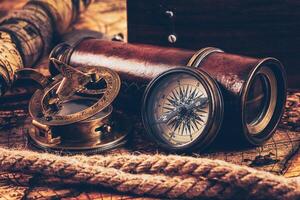 Old vintage compass on ancient map photo