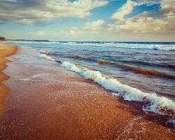 Wave surging on sand photo