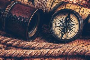 Old vintage compass on ancient map photo