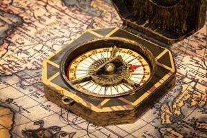 Vintage pirate compass on ancient map photo