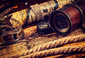 Old vintage compass on ancient map photo