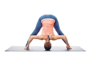 Woman doing yoga asana Prasarita padottanasana photo