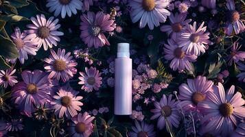 A cream bottle on a flower bed full of darker and light purple flowers. photo