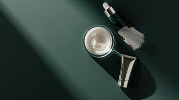 A dark green background with skincare products placed on it, surrounded by sunlight. photo