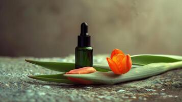 A bottle of green oil is placed on the long leaves, with an orange tulip next to it. photo