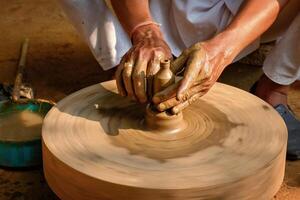 Indian potter hands at work, Shilpagram, Udaipur, Rajasthan, India photo