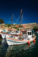 Fishing boats in harbour in fishing village of Mandrakia, Milos island, Greece photo