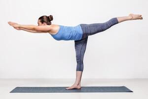 Sporty woman practices yoga asana photo