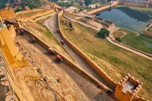 Tourists riding elephants on ascend to Amer fort photo