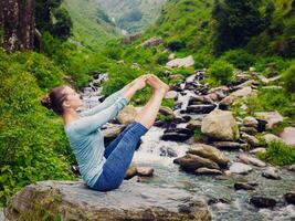 Woman doing Ashtanga Vinyasa Yoga asana outdoors photo