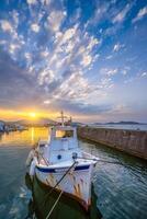 Fishing boat in port of Naousa on sunset. Paros lsland, Greece photo