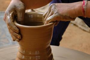 Indian potter hands at work, Shilpagram, Udaipur, Rajasthan, India photo