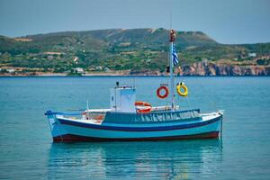 Greek fishing boat in Aegean sea near Milos island, Greece photo