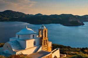 Greek Orthodox church in Plaka village on Milos island on sunset in Greece photo