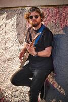 Street musician playing electric guitar in the street photo