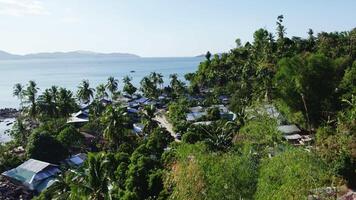 Poor fishing village in Asia on the seashore, drone view on a sunset video