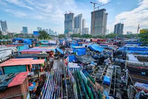 Dhobi Ghat is an open air laundromat lavoir in Mumbai, India with laundry drying on ropes photo