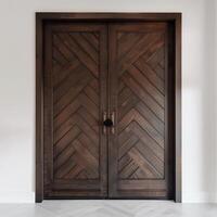 Dark brown wooden door with diagonal grooves on the surface with white wall in background. photo