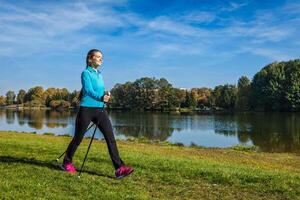 Young woman nordic walking photo