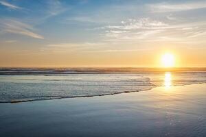 Atlantic ocean sunset with surging waves at Fonte da Telha beach, Portugal photo