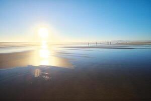 Atlantic ocean sunset with surging waves at Fonte da Telha beach, Portugal photo