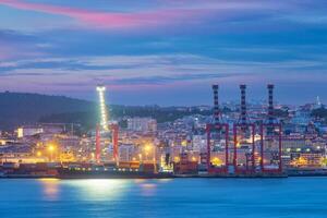 View of Lisbon port with ship and port cranes in the evening photo