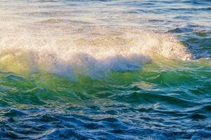 Breaking ocean wave on sunset photo