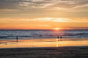 Atlantic ocean sunset with surging waves at Fonte da Telha beach, Portugal photo