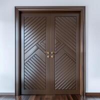 Dark brown wooden door with diagonal grooves on the surface with white wall in background. photo
