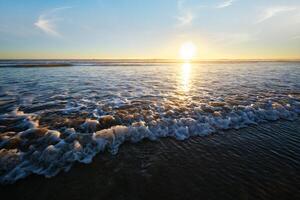 Atlantic ocean sunset with surging waves at Fonte da Telha beach, Portugal photo