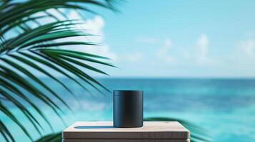 A matte black jar on an elegant wooden podium in front of the ocean with palm leaves. photo