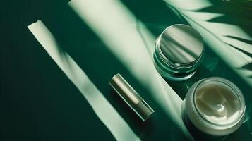 A dark green background with skincare products placed on it, surrounded by sunlight. photo