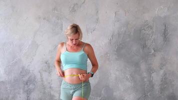 A pregnant woman measuring her stomach with measuring tape video