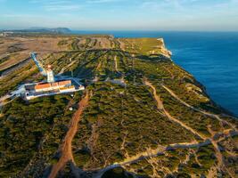 Lighthouse on Cabo Espichel cape Espichel on Atlantic ocean photo